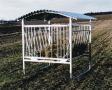 Feeder for sheep with a movable basket with roof